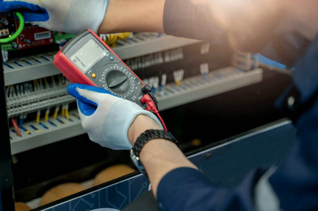 Electrician engineer work tester measuring voltage.